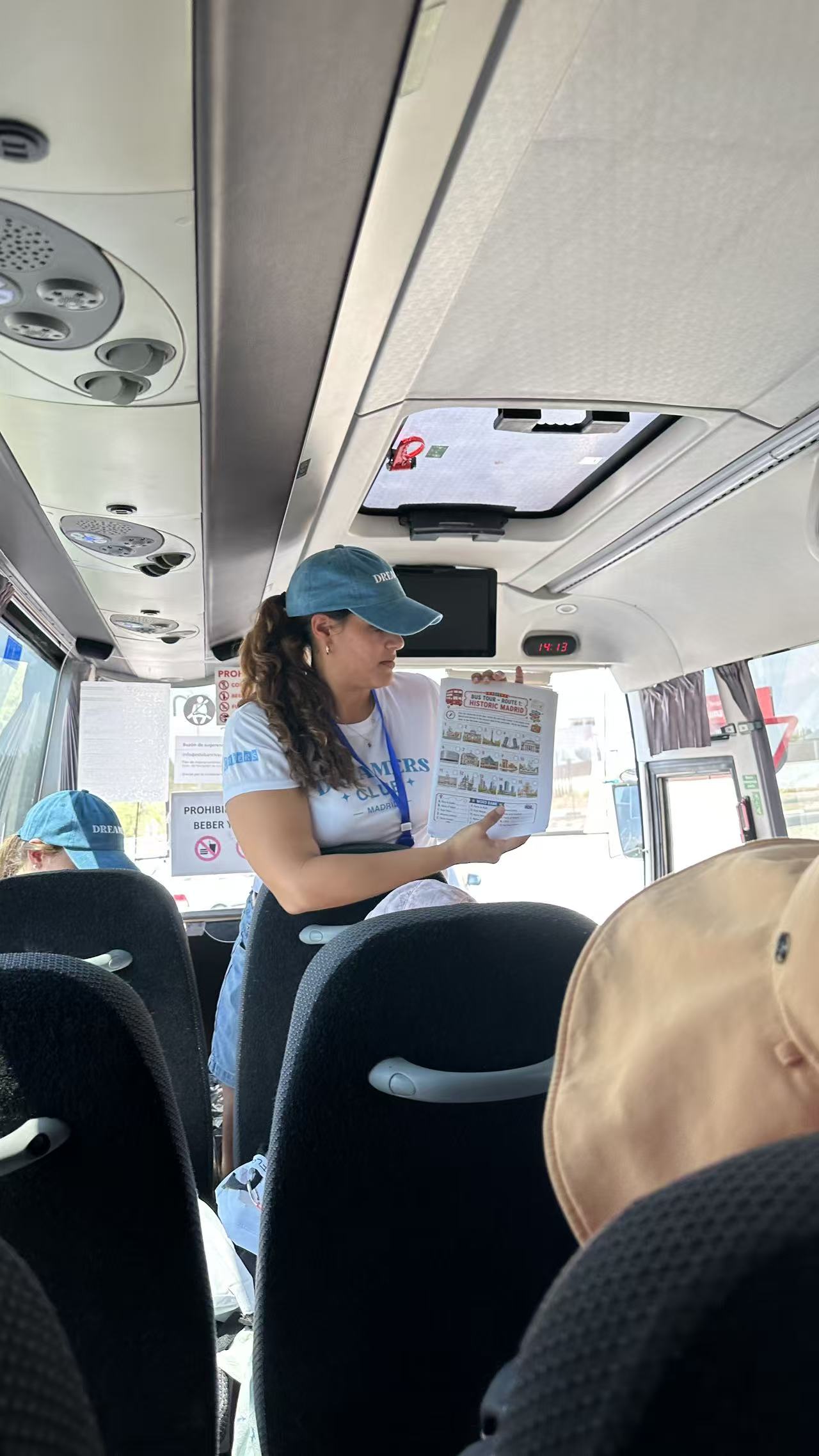 A Dream Leader sharing a Madrid city guide on the bus